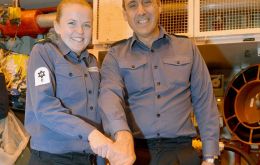 The youngest and oldest of the ship's company cut her birthday cake: WO Heath and Chef Lloyd-Williams