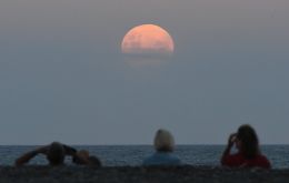 The moon, about as large as it can be in the sky, will turn a blood red color in the hours before dawn. 