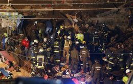 Rescue workers combed through the rubble to look for four other missing people beneath one of the many steep hills of the city’s historic quarter